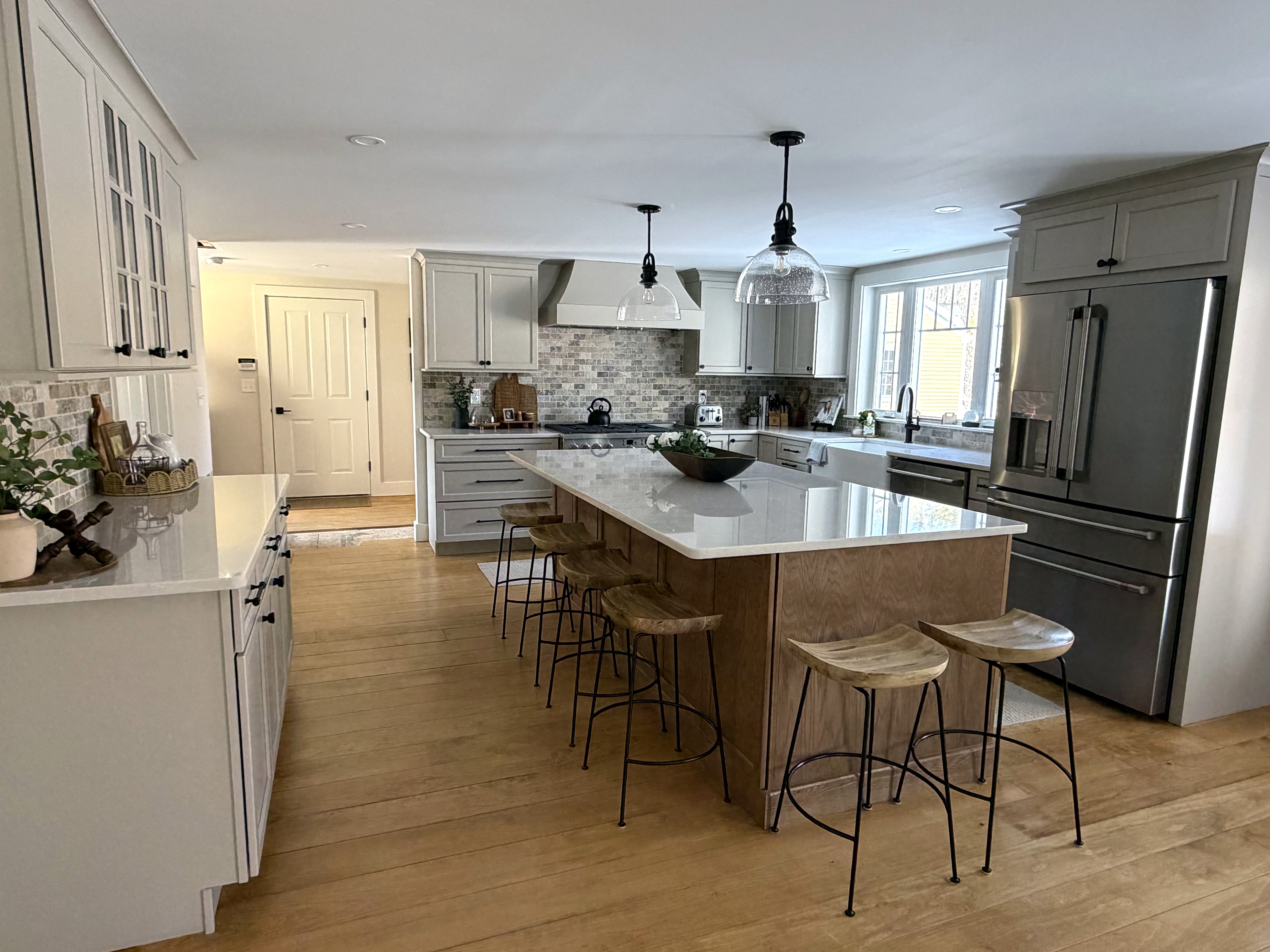 Open kitchen with a wood island and full-height cabinetry