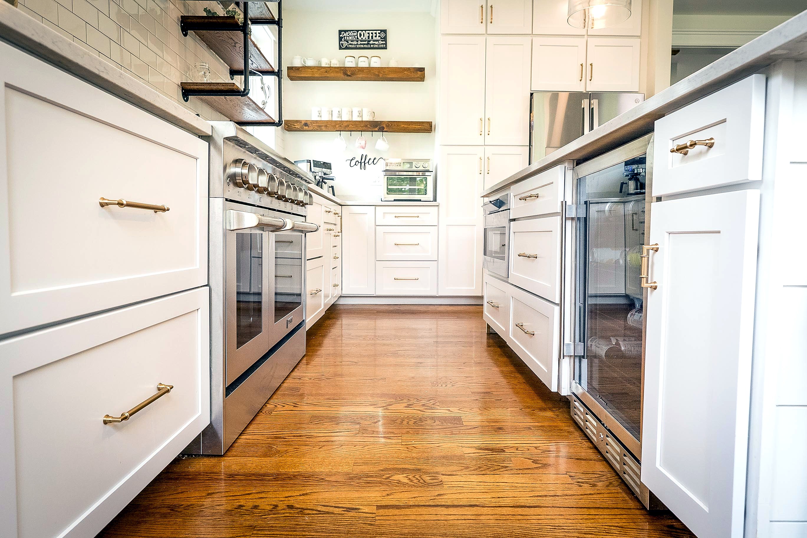 White shaker cabinets lining the kitchen work aisle