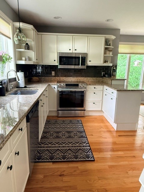Before: builder-grade range wall with microwave over the stove