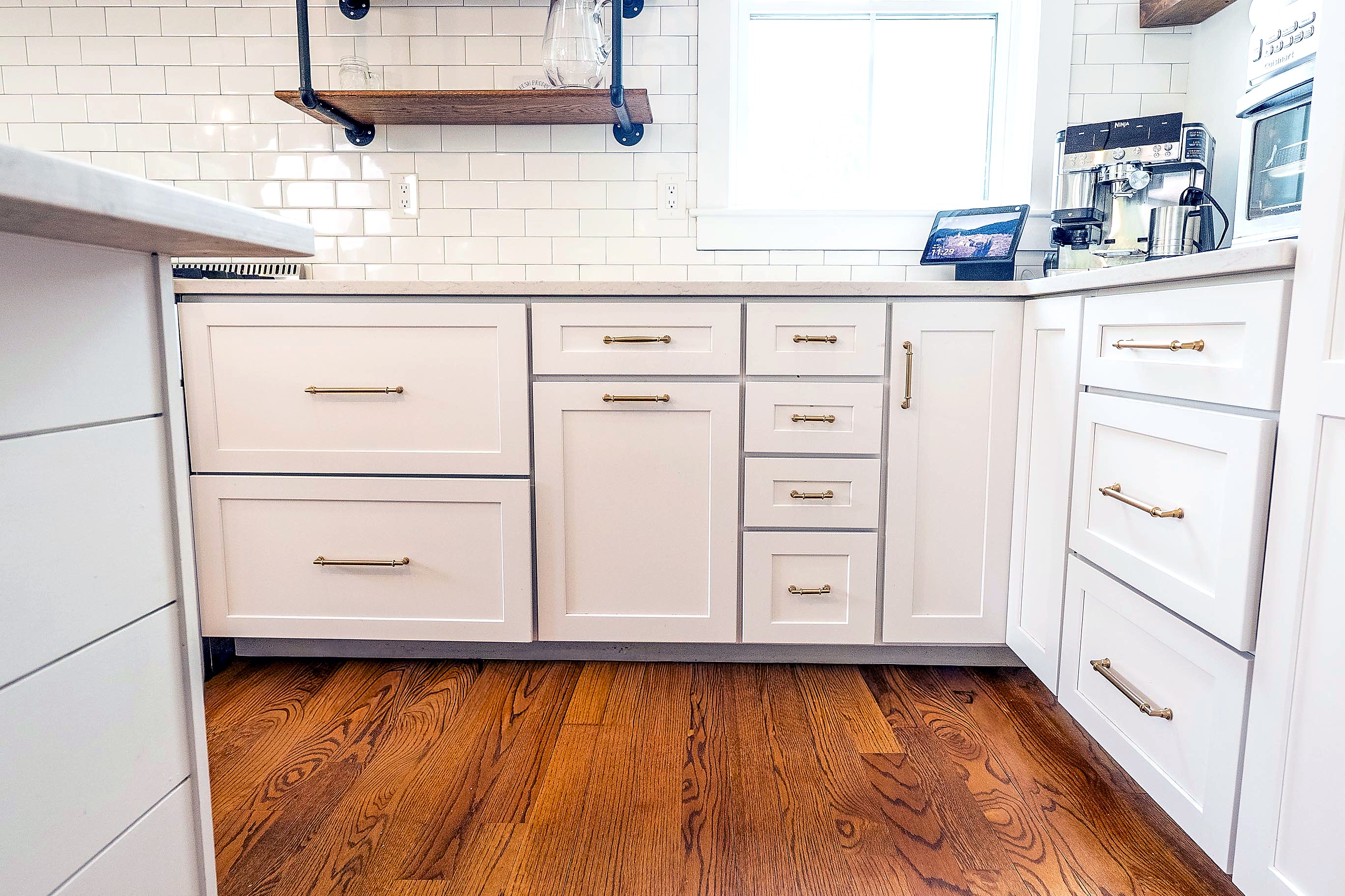 Shaker base cabinets with brass pulls and deep drawers