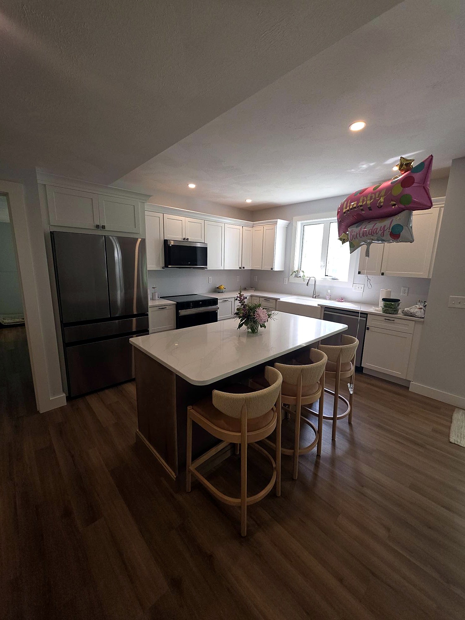Kitchen island with seating and white perimeter cabinets