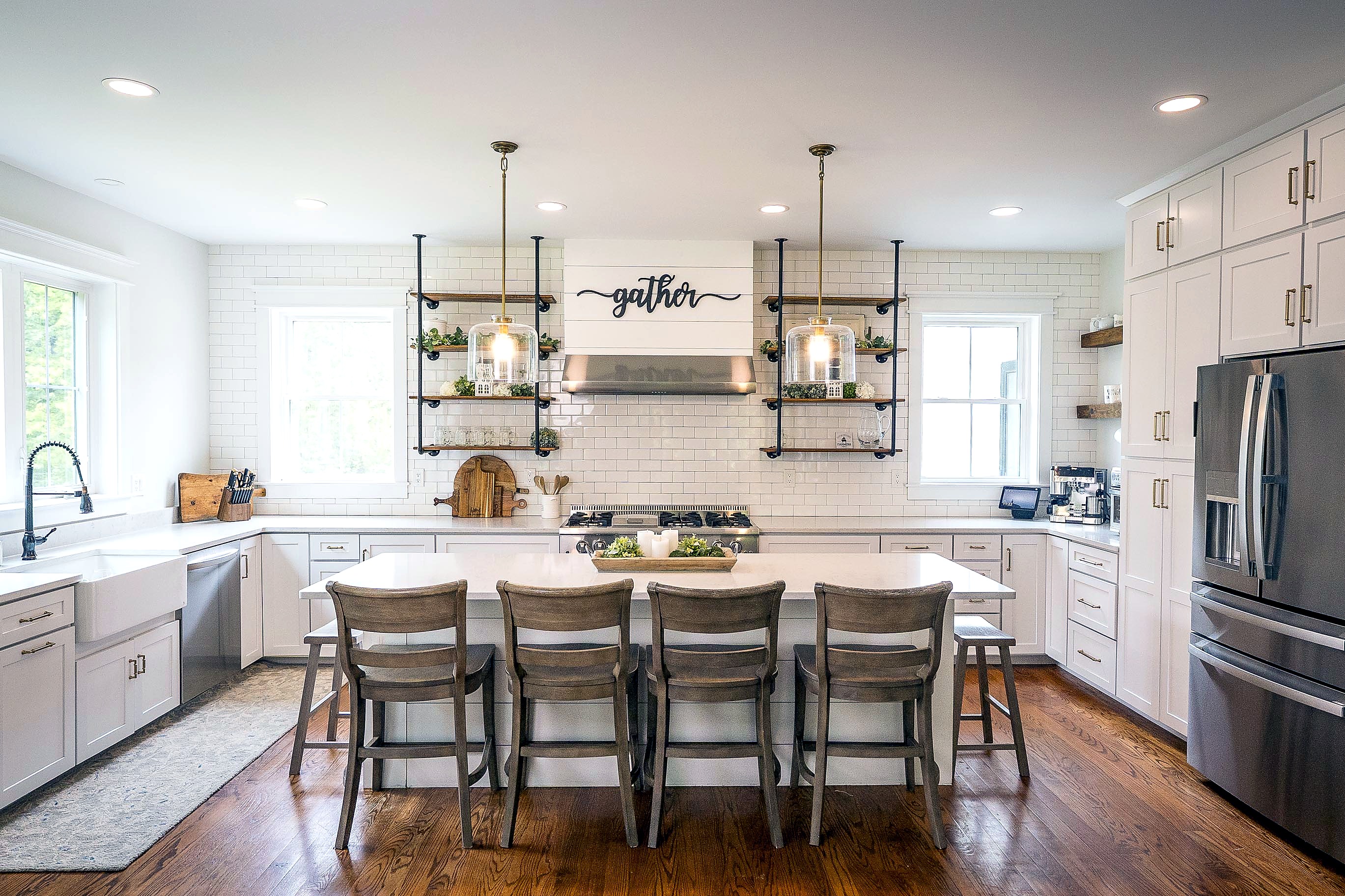 White shaker kitchen with a quartz island and open wood shelving
