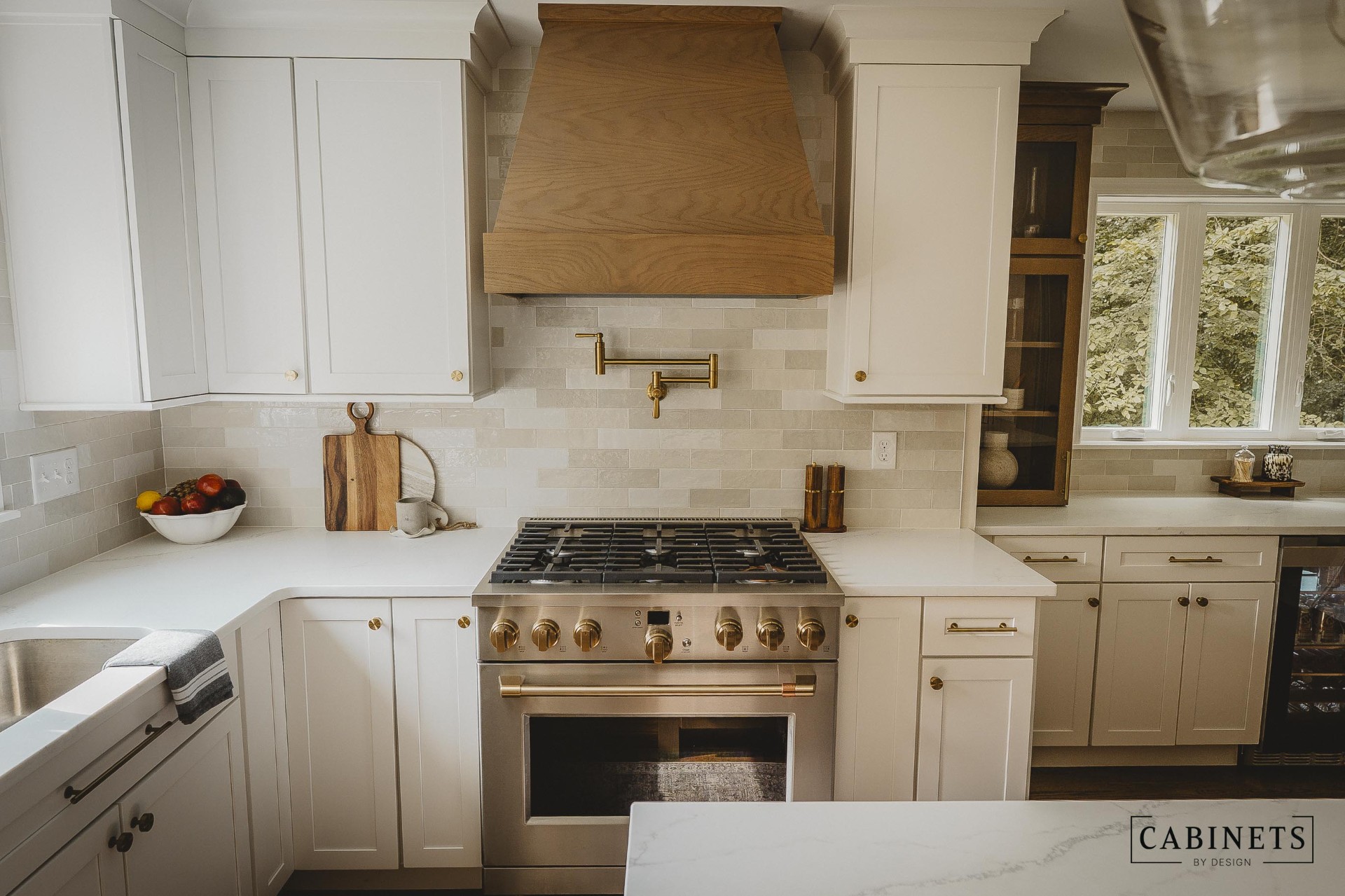 After: professional range with custom white oak hood and zellige tile backsplash