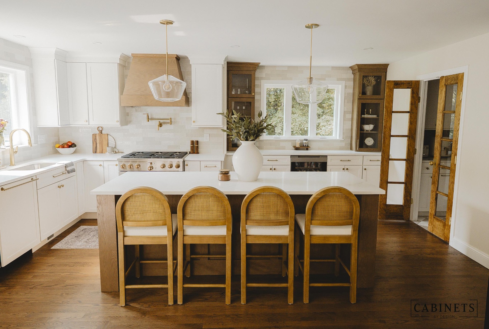 Finished Hollis NH kitchen with white cabinets, white oak island and brass hardware