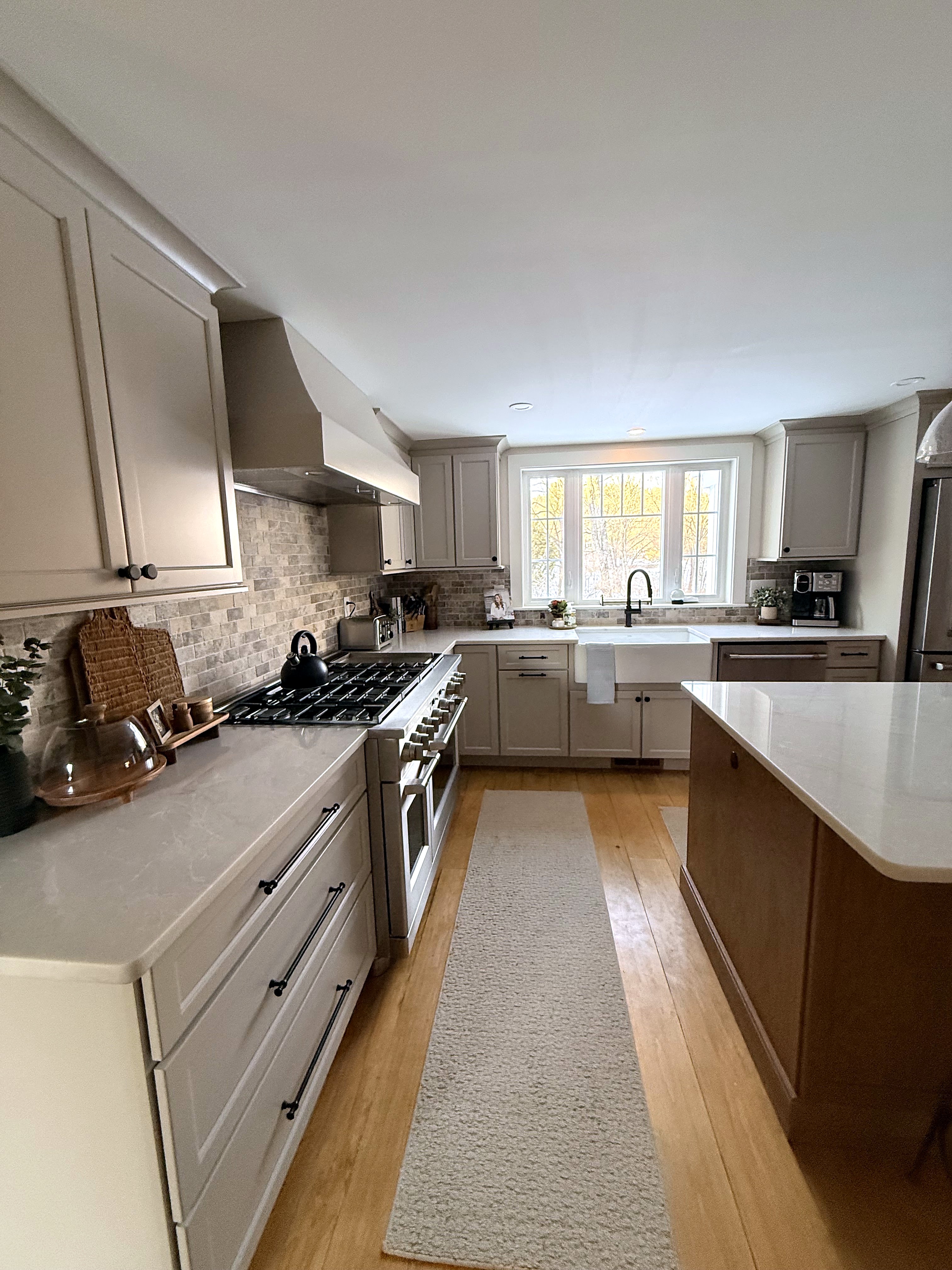 Kitchen perimeter cabinetry and a contrasting wood island
