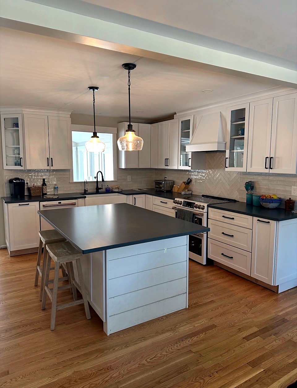 White kitchen cabinets with a contrasting dark island
